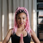 Woman in Black Sleeveless Top Wearing Pink Knit Cap