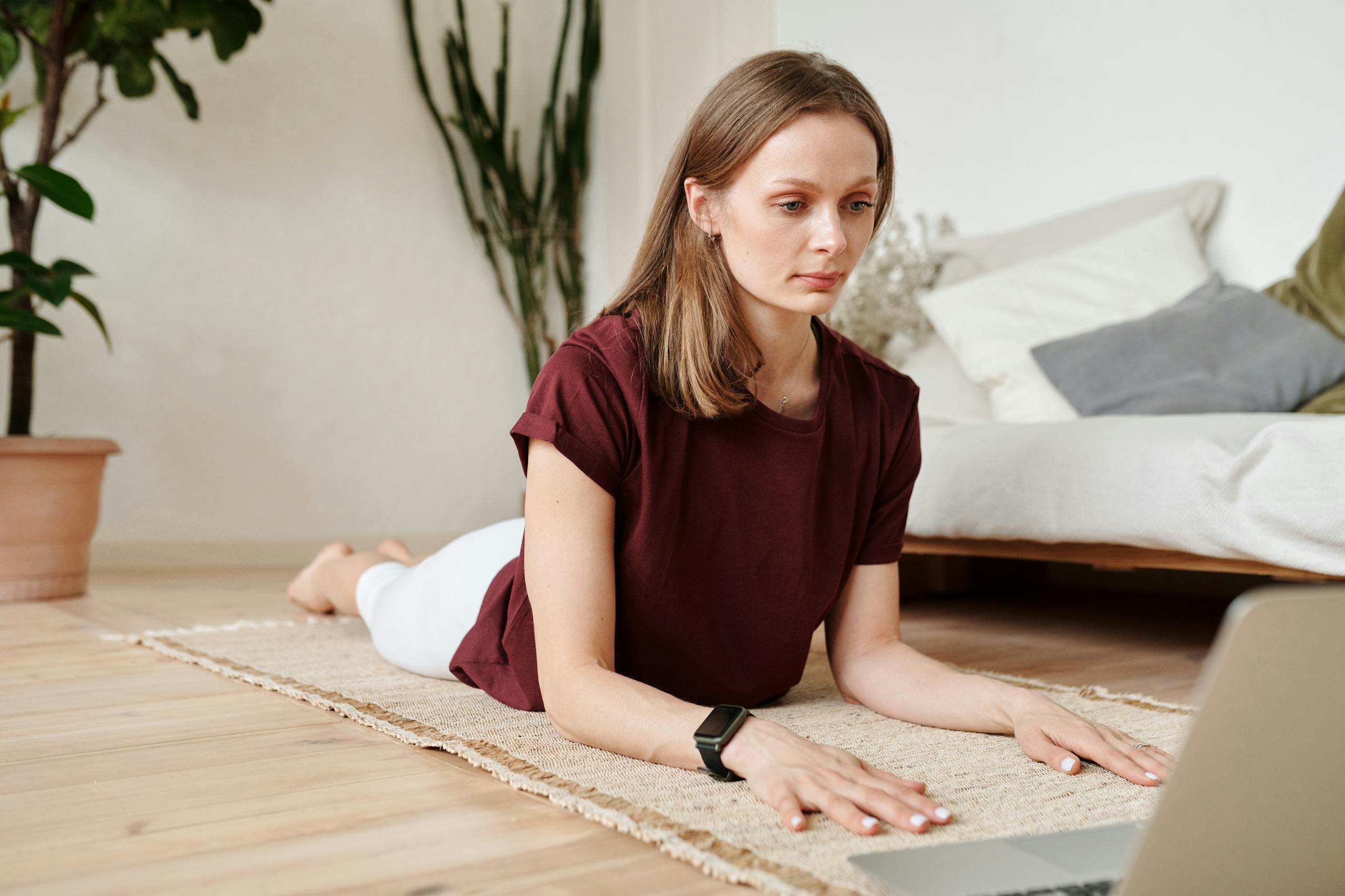 Woman in Maroon Shirt Lying on Carpet